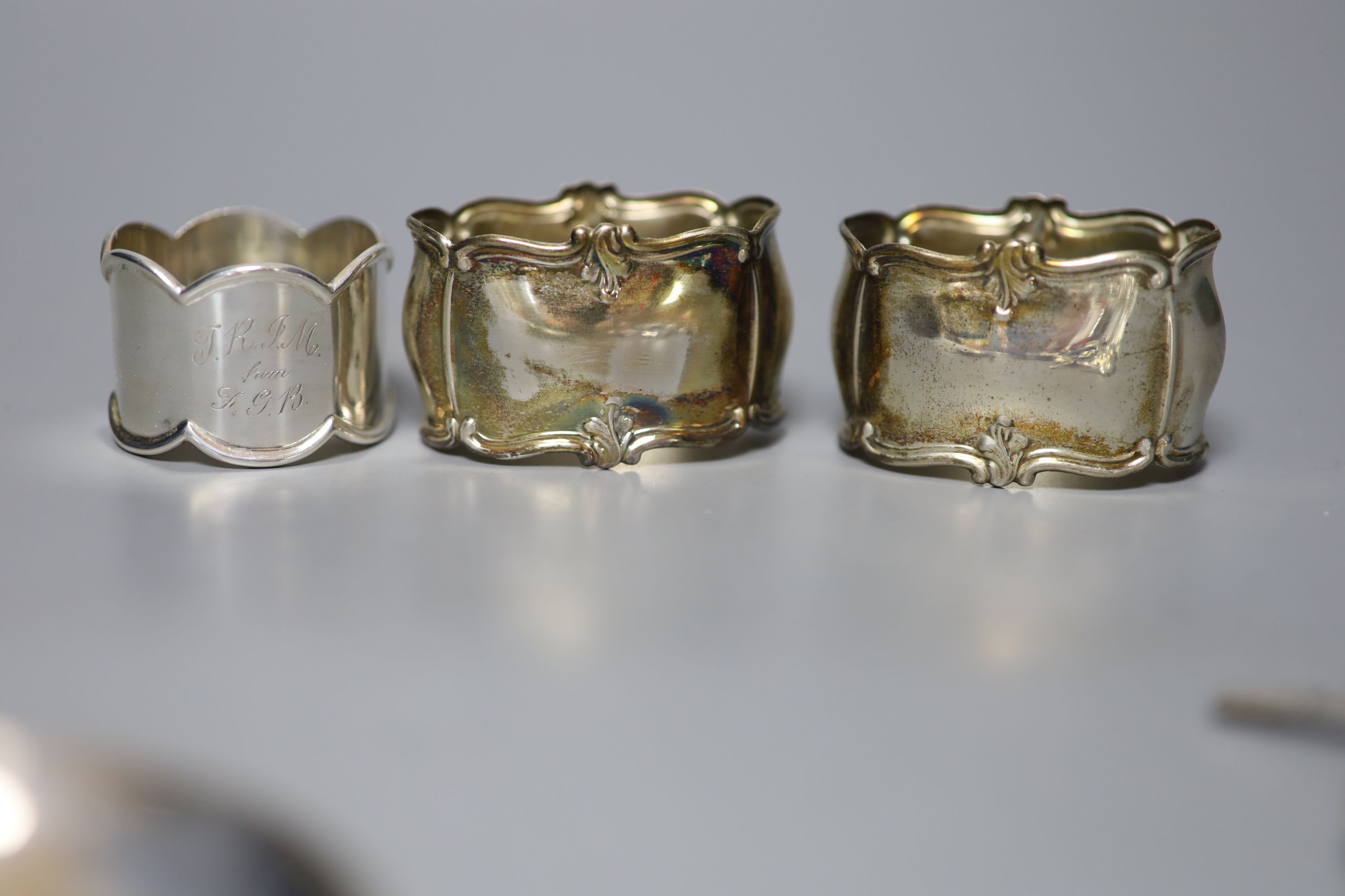 Two late 19th/early 20th century ornate pierced silver spoons, largest 23.7cm, a silver dish, sterling spoon and three napkin rings